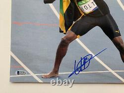 Usain Bolt Autographed 14 x 11 Photo Signed sprinter gold medal Beckett BAS coa